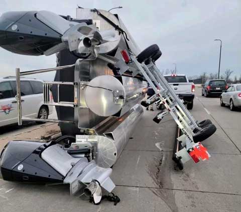 overturned pontoon bvoat on trailer